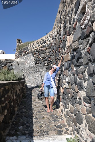 Image of Greek woman on the streets of Oia, Santorini, Greece