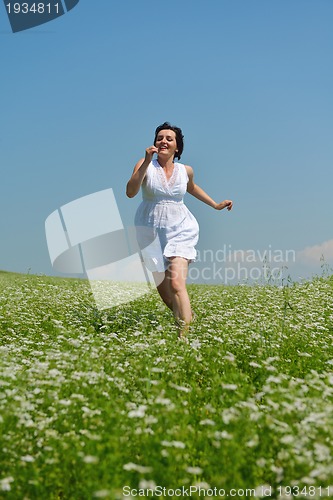 Image of Young happy woman in green field