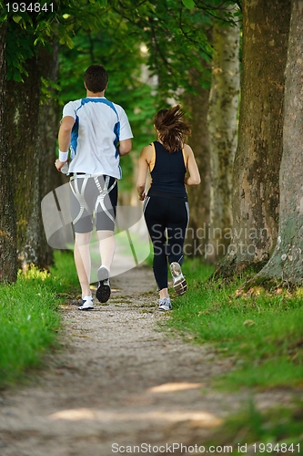 Image of Young couple jogging