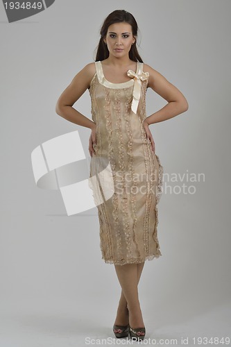 Image of elegant woman in fashionable dress posing in the studio
