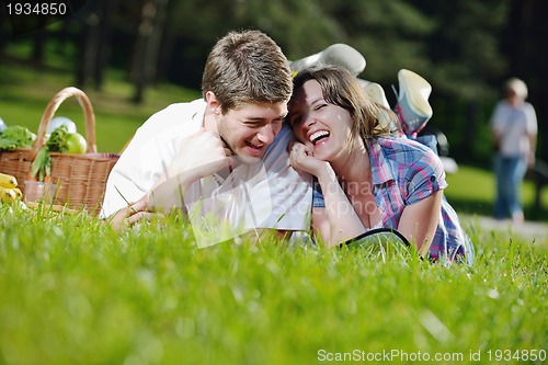Image of happy young couple having a picnic outdoor