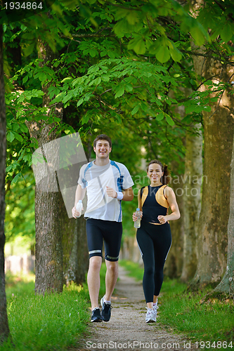 Image of Young couple jogging