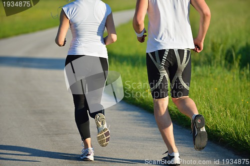 Image of Young couple jogging at morning