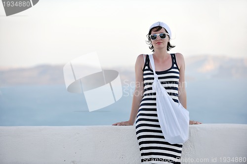 Image of Greek woman on the streets of Oia, Santorini, Greece