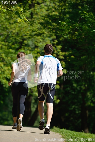 Image of Young couple jogging at morning