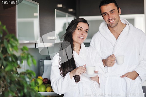 Image of Young love couple taking fresh morning cup of coffee