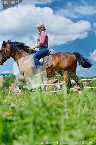 Image of happy woman  ride  horse