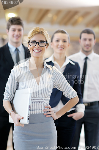 Image of business woman standing with her staff at conference
