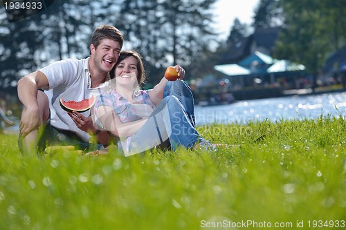 Image of happy young couple having a picnic outdoor