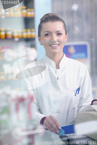 Image of pharmacist chemist woman standing in pharmacy drugstore