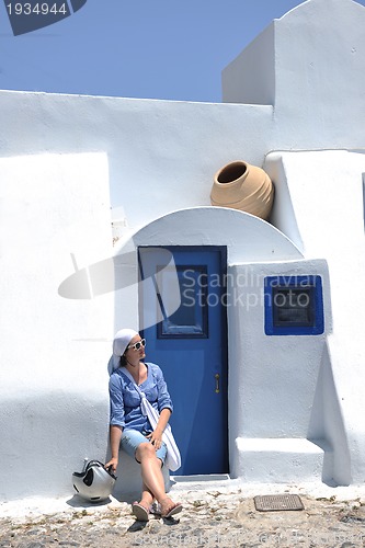Image of Greek woman on the streets of Oia, Santorini, Greece