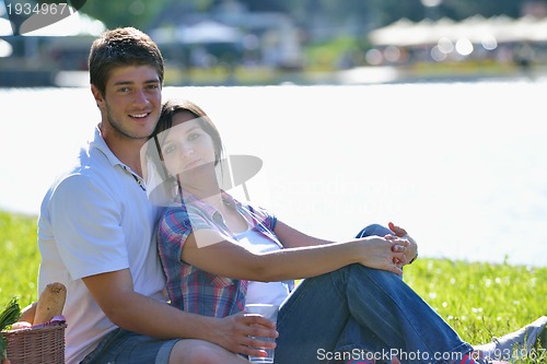 Image of happy young couple having a picnic outdoor