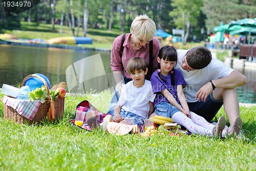 Image of Happy family playing together in a picnic outdoors