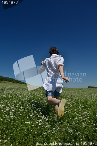 Image of Young happy woman in green field