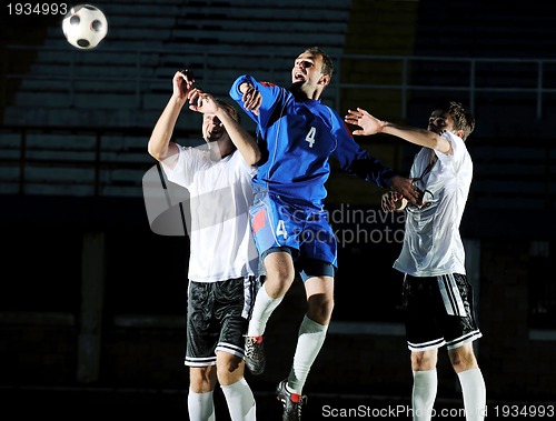 Image of football players in action for the ball