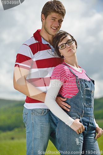 Image of Portrait of romantic young couple smiling together outdoor