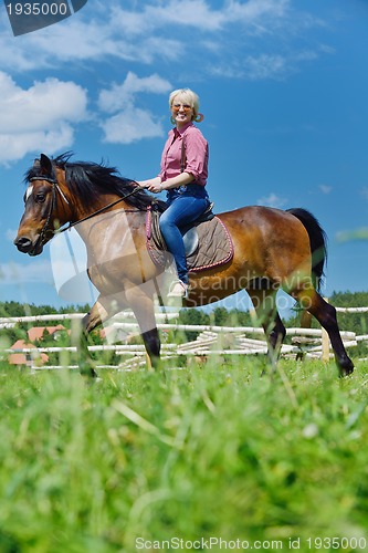 Image of happy woman  ride  horse
