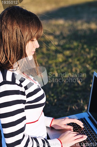 Image of young teen girl work on laptop outdoor