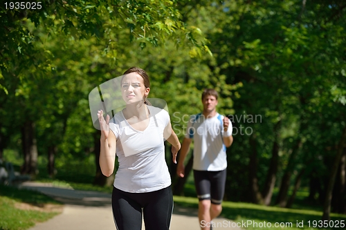 Image of Young couple jogging at morning