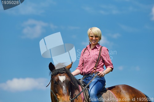 Image of happy woman  ride  horse