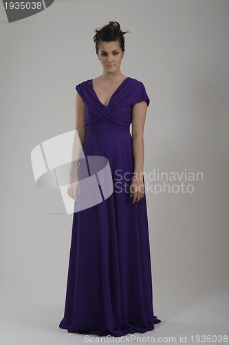 Image of elegant woman in fashionable dress posing in the studio