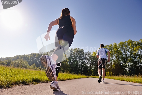 Image of Young couple jogging