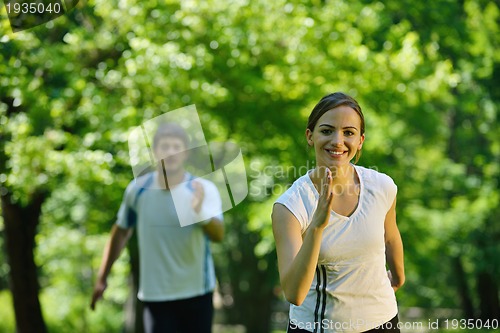 Image of Young couple jogging at morning