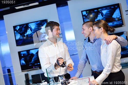 Image of Young couple in consumer electronics store