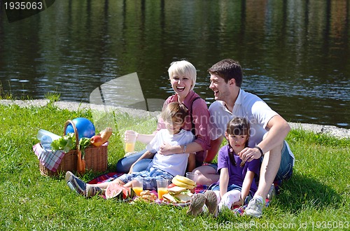 Image of Happy family playing together in a picnic outdoors