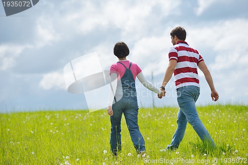 Image of Portrait of romantic young couple smiling together outdoor