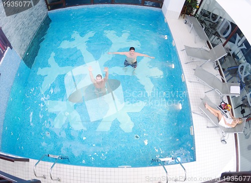 Image of young people group at spa swimming pool