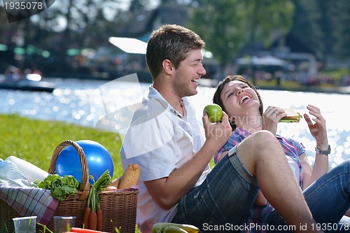 Image of happy young couple having a picnic outdoor