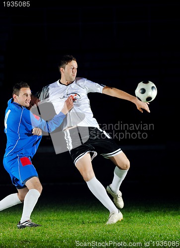 Image of football players in action for the ball