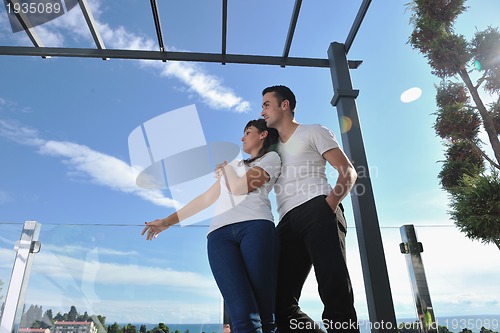 Image of couple relaxing on balcony