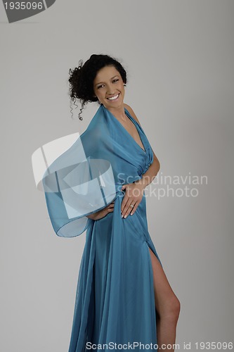 Image of elegant woman in fashionable dress posing in the studio