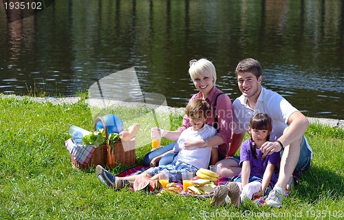 Image of Happy family playing together in a picnic outdoors