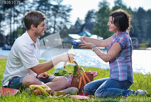 Image of happy young couple having a picnic outdoor