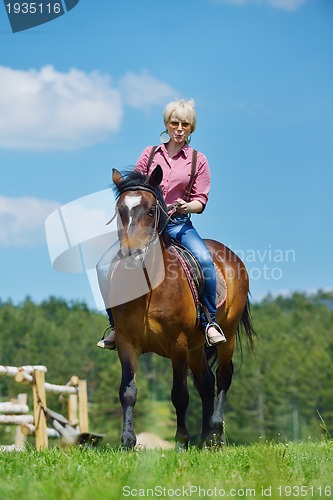 Image of happy woman  ride  horse