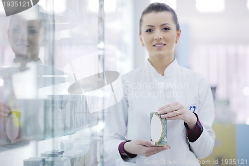 Image of pharmacist chemist woman standing in pharmacy drugstore