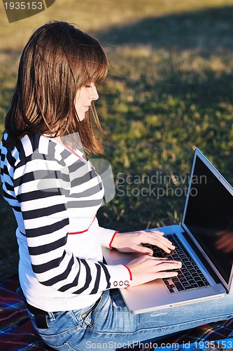 Image of young teen girl work on laptop outdoor