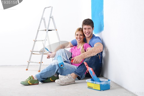 Image of happy young cople relaxing after painting in new home