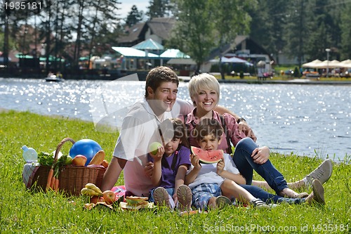 Image of Happy family playing together in a picnic outdoors
