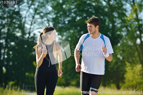 Image of Young couple jogging at morning