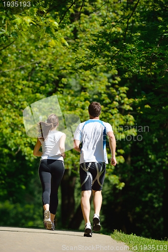 Image of Young couple jogging