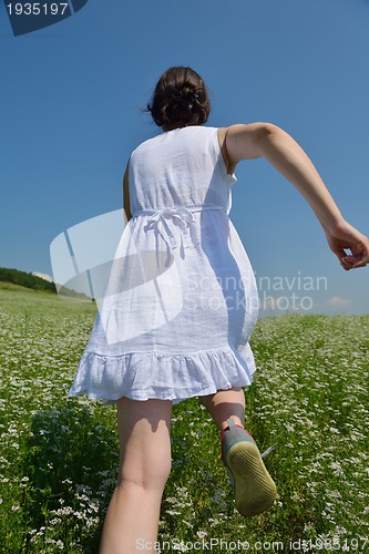 Image of Young happy woman in green field