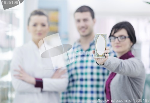 Image of pharmacist suggesting medical drug to buyer in pharmacy drugstor