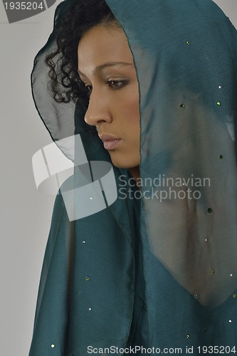 Image of elegant woman in fashionable dress posing in the studio