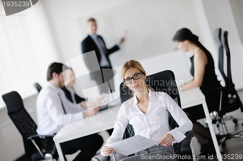 Image of business woman with her staff in background