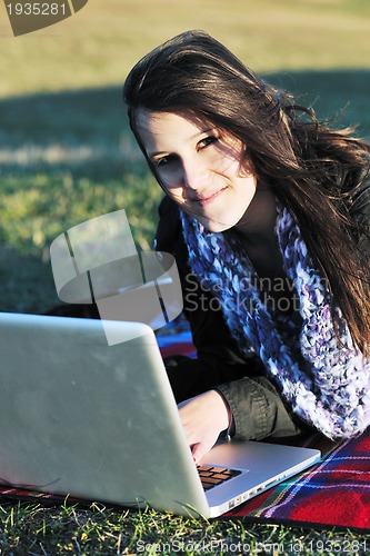Image of young teen girl work on laptop outdoor