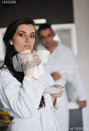 Image of Young love couple taking fresh morning cup of coffee